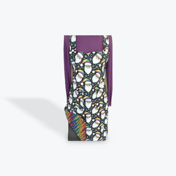 A reversible adult apron featuring a colorful Santa patter on one side and a multi color splatter on the reverse, with pockets on both sides.